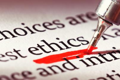 A highlighter underlines the word 'ethics' heavily in a business document or textbook. 
